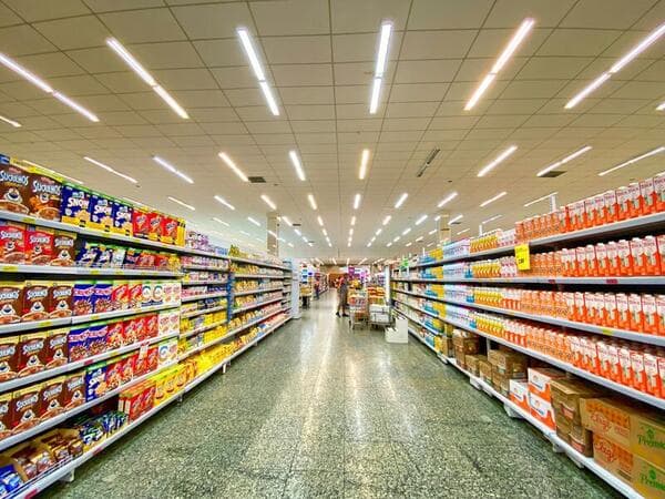Supermarket staff stocking shelves in a retail store